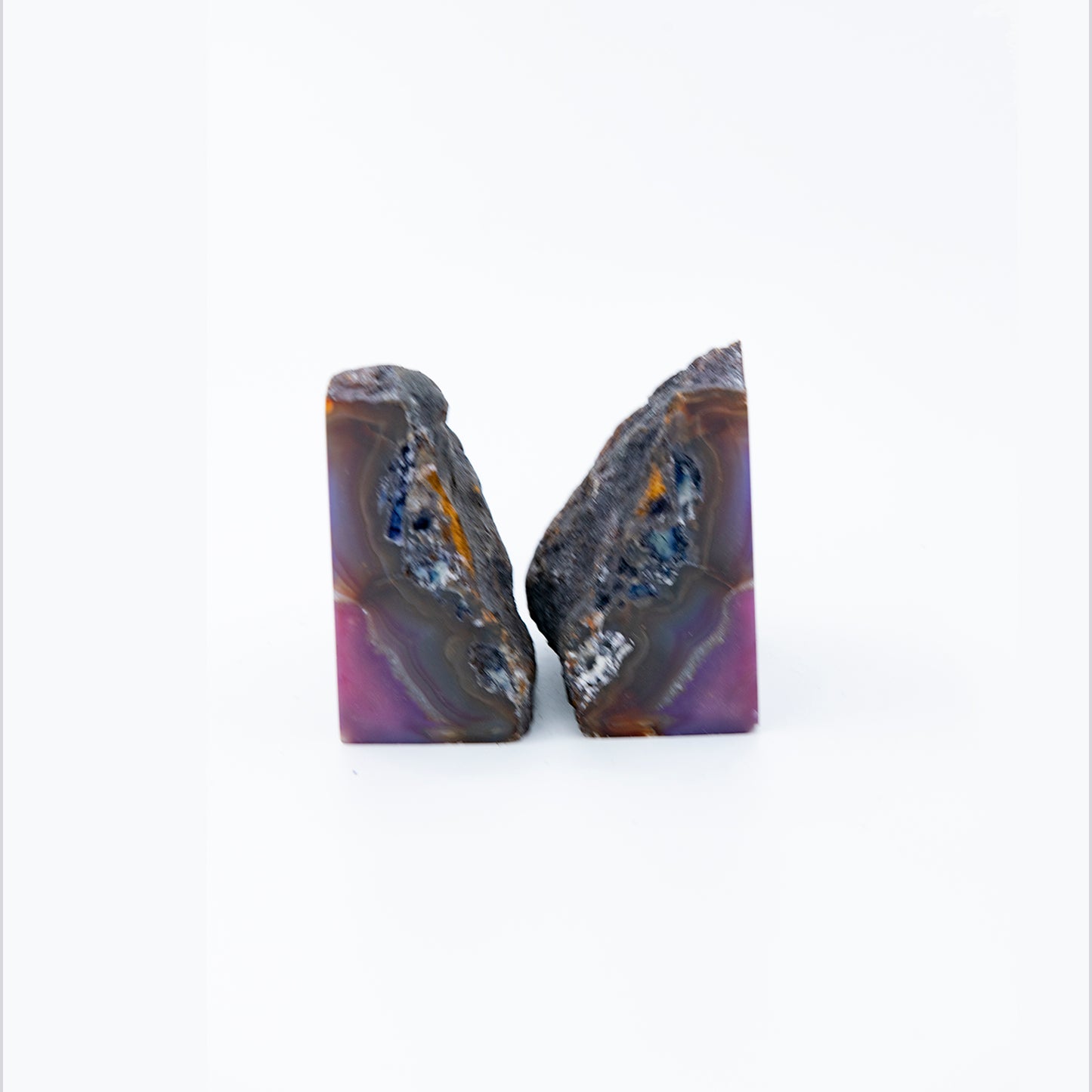 Brazilian Agate Bookends. Beautifully figured Agate bookends. Size 7 inches wide and 4 inches high. Purple color has been added.