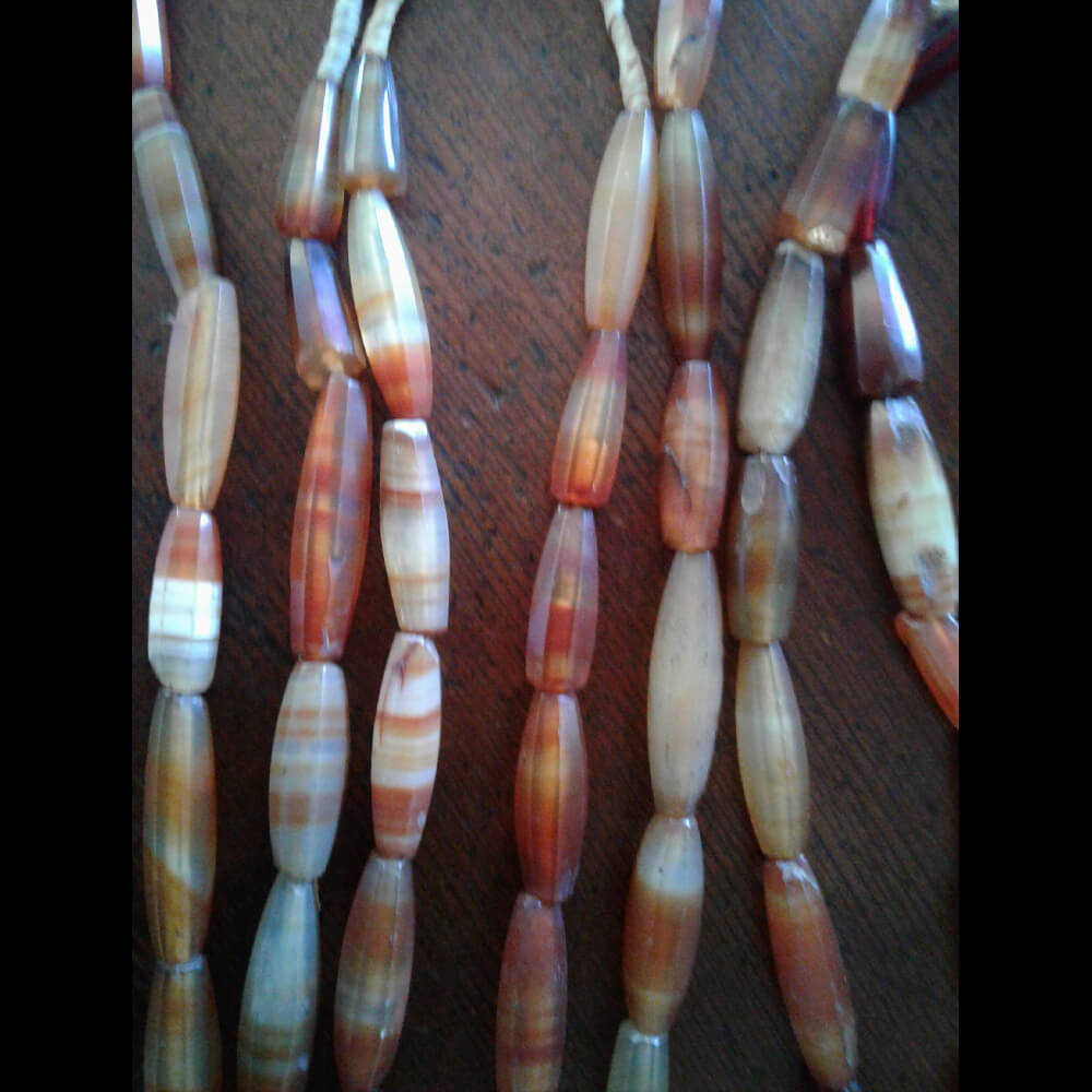 Antique faceted Carnelian 22 inch bead strands. The beads range from 1 inch in length to 1 3/4 inch. The Carnelian is beautiful with a nice polish for over 100 years old. Some beads are nicked with minimal damage as they have been worn for decades. These are restrung for the current market. They were made in Idar Oberstein, Germany over 100 years ago for trade with Africa. Hard to find, old and rare.