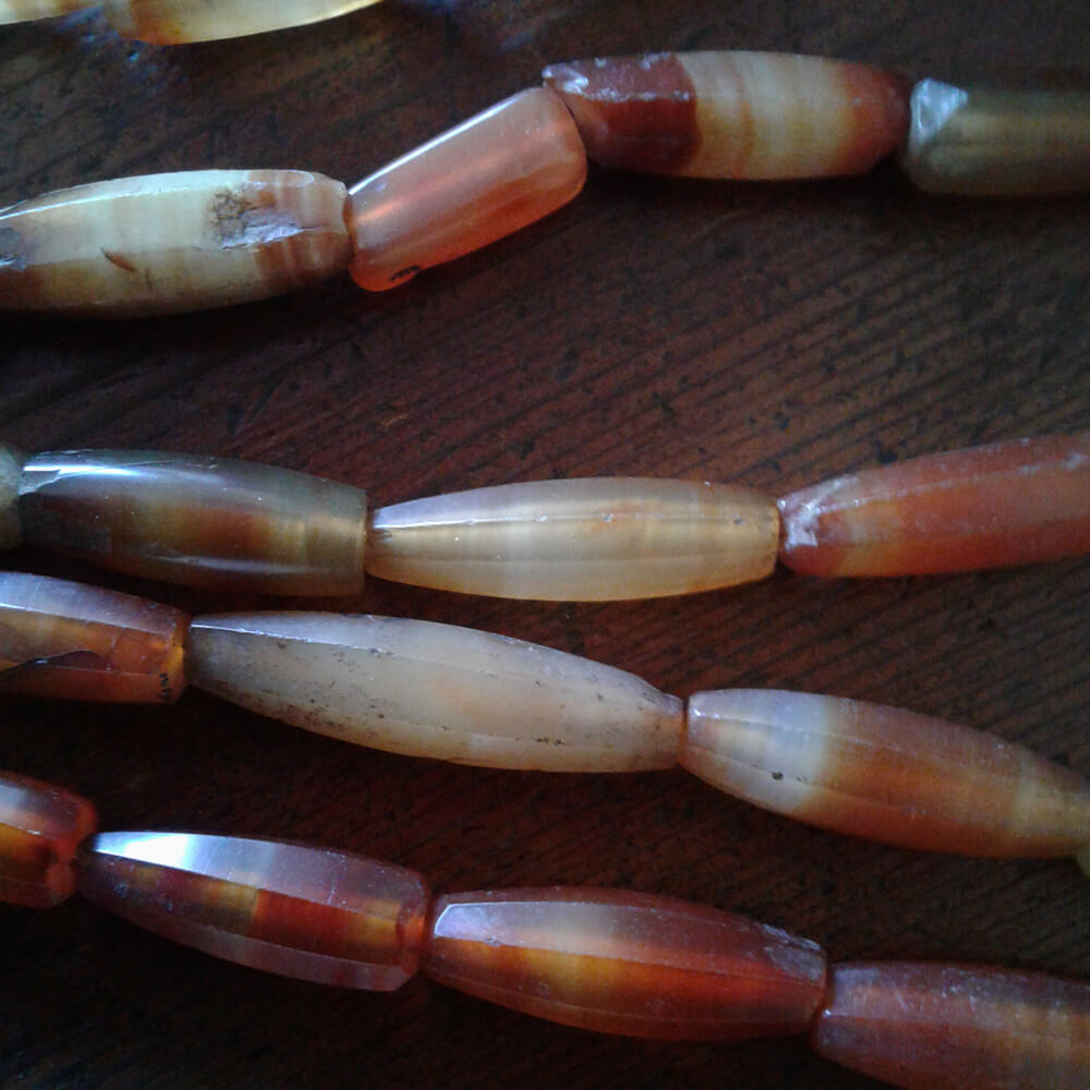 Antique faceted Carnelian 22 inch bead strands. The beads range from 1 inch in length to 1 3/4 inch. The Carnelian is beautiful with a nice polish for over 100 years old. Some beads are nicked with minimal damage as they have been worn for decades. These are restrung for the current market. They were made in Idar Oberstein, Germany over 100 years ago for trade with Africa. Hard to find, old and rare.