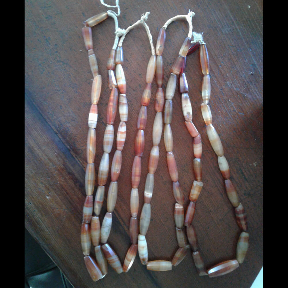 Antique faceted Carnelian 22 inch bead strands. The beads range from 1 inch in length to 1 3/4 inch. The Carnelian is beautiful with a nice polish for over 100 years old. Some beads are nicked with minimal damage as they have been worn for decades. These are restrung for the current market. They were made in Idar Oberstein, Germany over 100 years ago for trade with Africa. Hard to find, old and rare.
