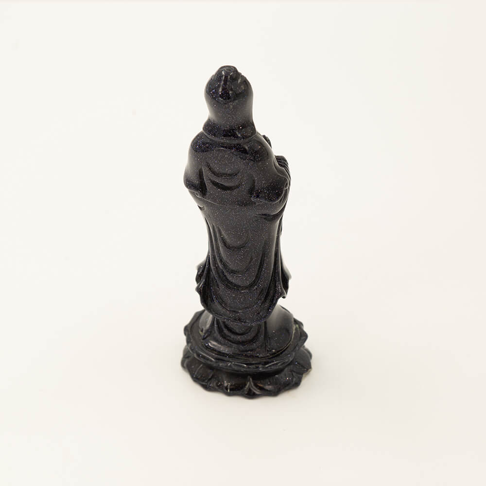 Beautiful, detailed Kwan Yin statue made from Blue Goldstone. Goldstone is a man-made quartz glass infused with copper particles, invented in 17th century Venice, Italy. It is said to be an ideal stone for empaths. Gorgeous, sparkly depth of color. Size: 6x1.5x2 inches.
