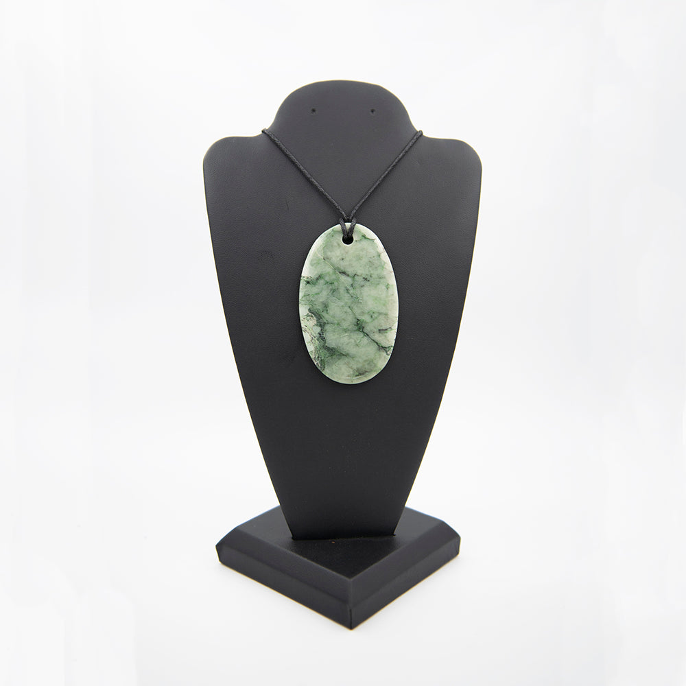 RiverBlossom Jade Oval Pendant. Nice color and polish are featured on this highly patterned beauty. The Jade used in this piece was sourced from our helicopter trips to our private property in the Trinity Alps area in California. We call this "RiverBlossom Jade" as the winter storms create high water that delivers the jade for us to simply pick up as the water recedes in the summer.