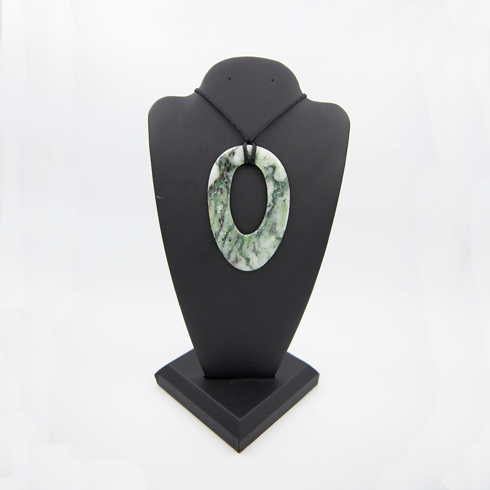 RiverBlossom Jade Large Pendant. A striking Jade piece with unusual shape, great color and patterns. One of a kind. Almost 3.5 inches tall and a bit over 2 inches wide but light in weight due to the nice open center.