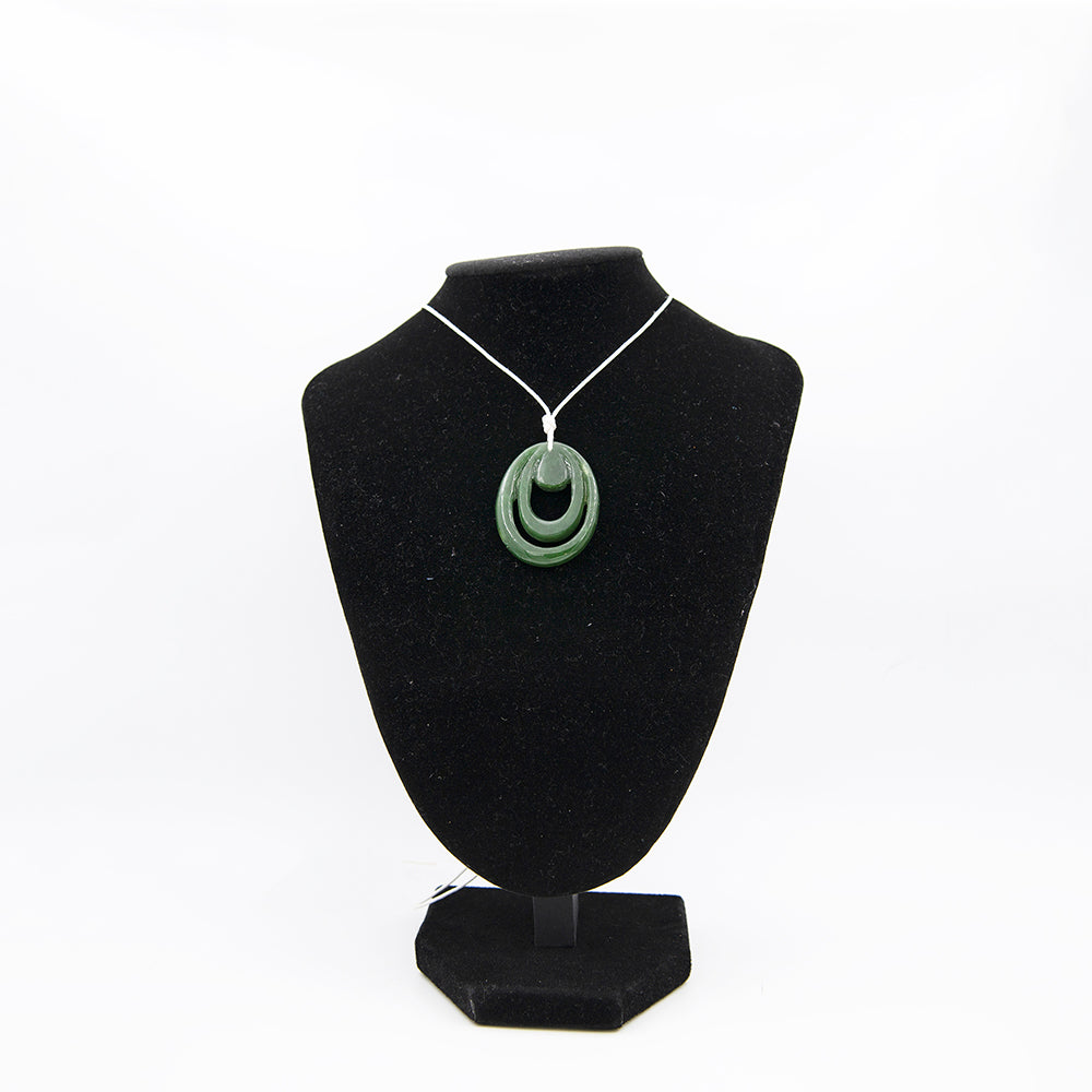 New Zealand Maori Style Jade Pendant.  Green translucent Jade from Deese Lake, Canada.  This is a New Zealand Maori style carving. Size is over 1.5 inches tall and over 1.25 inches wide.