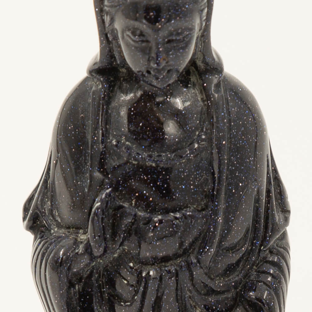 Beautiful, detailed Kwan Yin statue made from Blue Goldstone. Goldstone is a man-made quartz glass infused with copper particles, invented in 17th century Venice, Italy. It is said to be an ideal stone for empaths. Gorgeous, sparkly depth of color. Size: 6x1.5x2 inches.