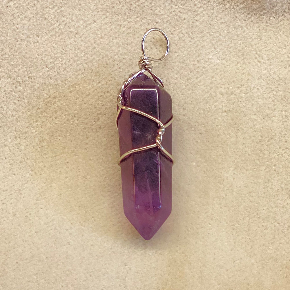 Handmade Purple Amethyst wire wrapped pendant. Average pendant size one 1 1/4 in. Wrapped nicely in stainless steel wire.