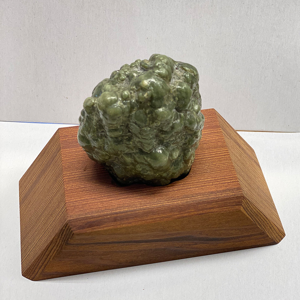 Suiseki, or Viewing Stone. Botryoidal ("bubbly") RiverBlossom Jade. I cleaned and polished this nugget down to 20,000 diamond grit. Base is carved to fit the stone. 2.5x2.5x1.5 inches. The polish is super fine...basically impeccably polished by hand with diamond pastes. The base is old growth redwood.