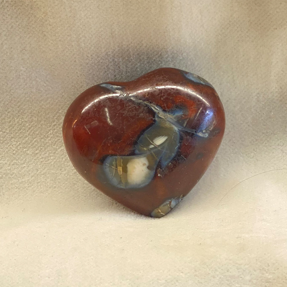 Handcrafted Carnelian Heart with contrasting deep reds, brown, black, white and maybe even a little orange pattern. Size: approx. 1.25 inches.