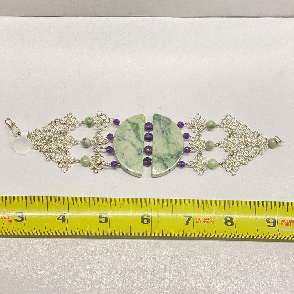 RiverBlossom Jade and Amethyst Bracelet. A spectacular showpiece to brag about. The finest California sourced Jade handcrafted into an extraordinary bracelet with Uruguayan Amethyst and intricate sterling silver wire work. The Jade used in this piece was sourced from our helicopter trips to our private property in the Trinity Alps area in California.