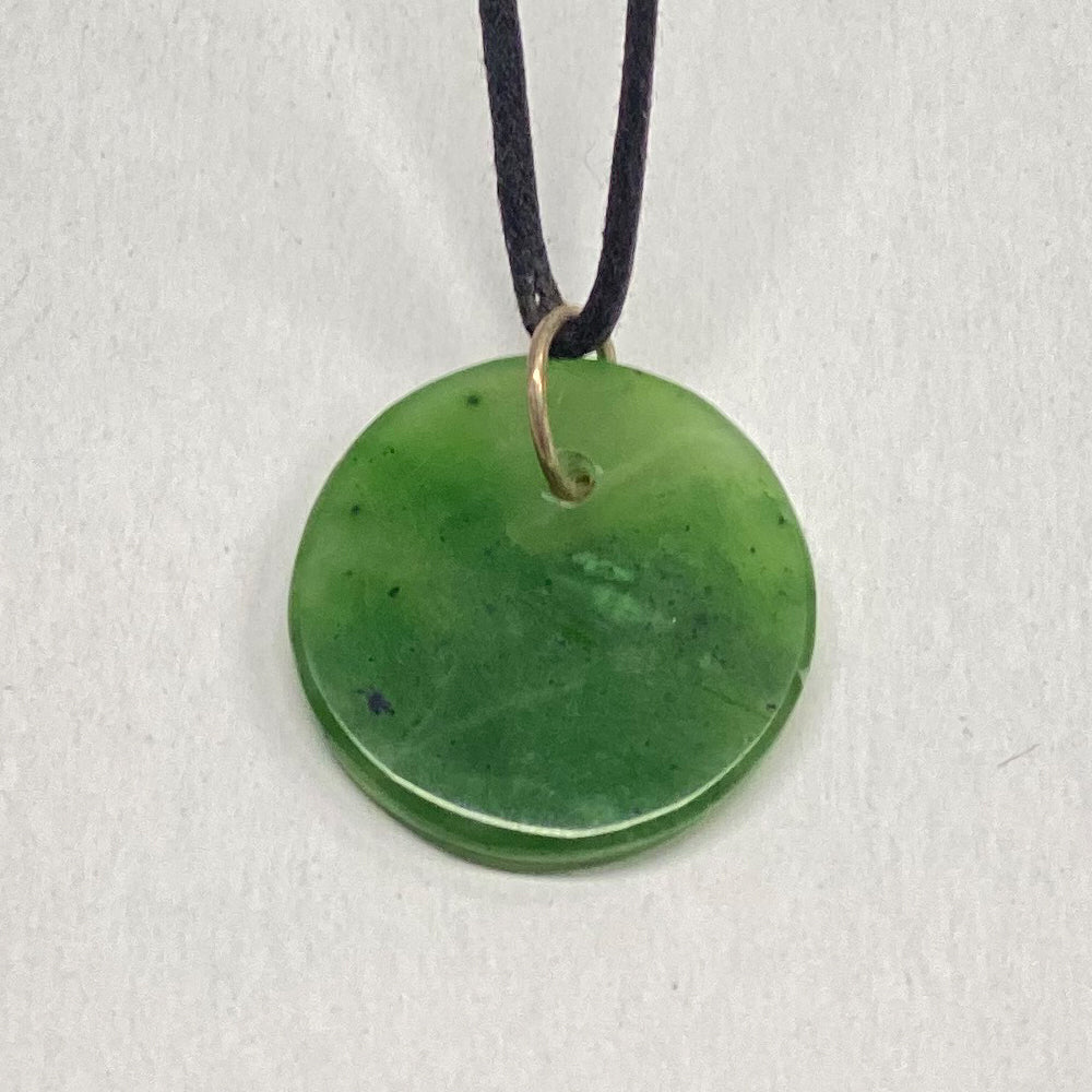 Mendocino Jade Circle Pendant. Very translucent jade from Mendocino California. This unique piece is light green and a little over an inch in diameter. This is the exact piece you will receive.