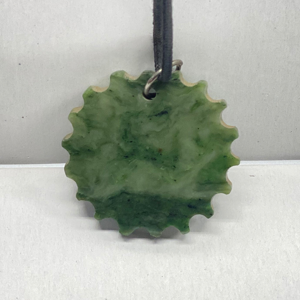 Covelo California Jade Sun. Sun shaped pendant with the horizon in the jade itself. 1.75 inch diameter.