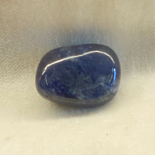 Tumbled Lapis Lazuli stone.  Smooth, polished surface.  Beautiful blue color. The size is less than one inch