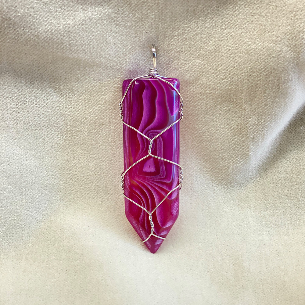 Wire Wrapped Fuchsia Agate Pendant.  Artisan made.  Stainless steel wrapping.  Size varies slightly.  Average size: 2.25 x .75  inches.  It has been said agate has a stabilizing effect.