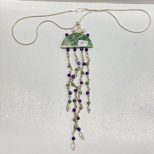 Unique RiverBlossom Jade and Amethyst Necklace Pendant.  Beautiful RiverBlossom Jade, Amethyst and Sterling wire worked pendant.  Absolutely no one will have a piece anything like this.  The jade used in this piece was sourced from our helicopter trips to our private property in the Trinity Alps area in California.