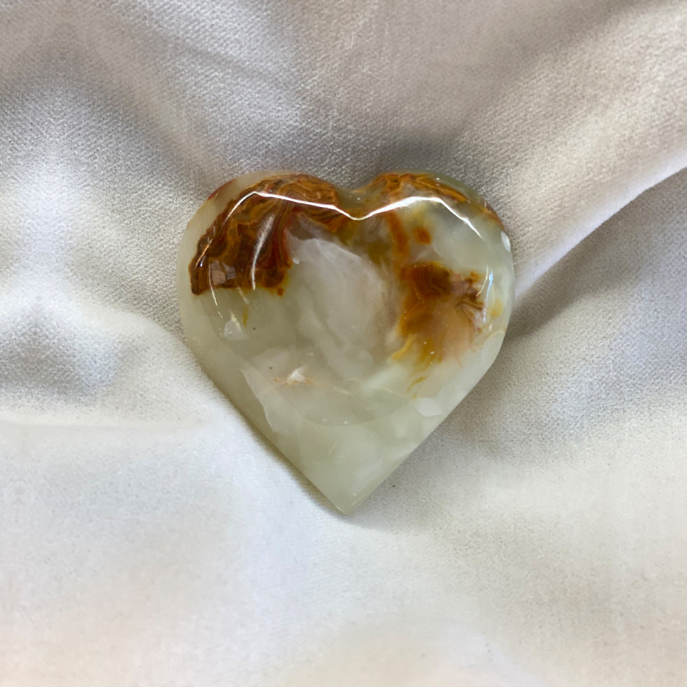 Hand Carved Onyx Heart. Unique patterns and colors in these. Sizes vary but are around 2+ inches.Folklore has it that onyx is a stone of positivity and healing.