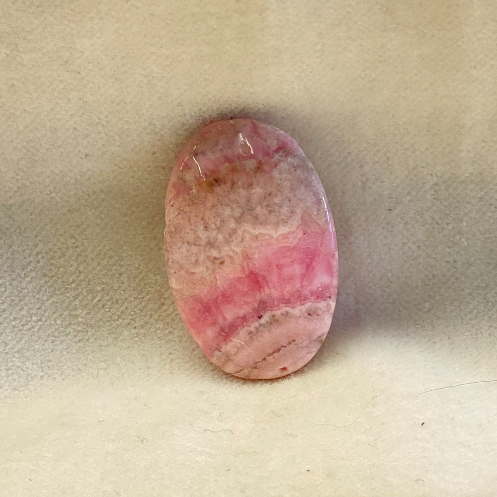 Rhodochrosite Oval Bead.  Handcrafted Rhodochrosite Flat Oval beads with stringing hole.  Polished smooth.  Size 1 1/4 inch. Really nice quality and hard to find.  Mystics call Rhodochrosite the stone of Love.