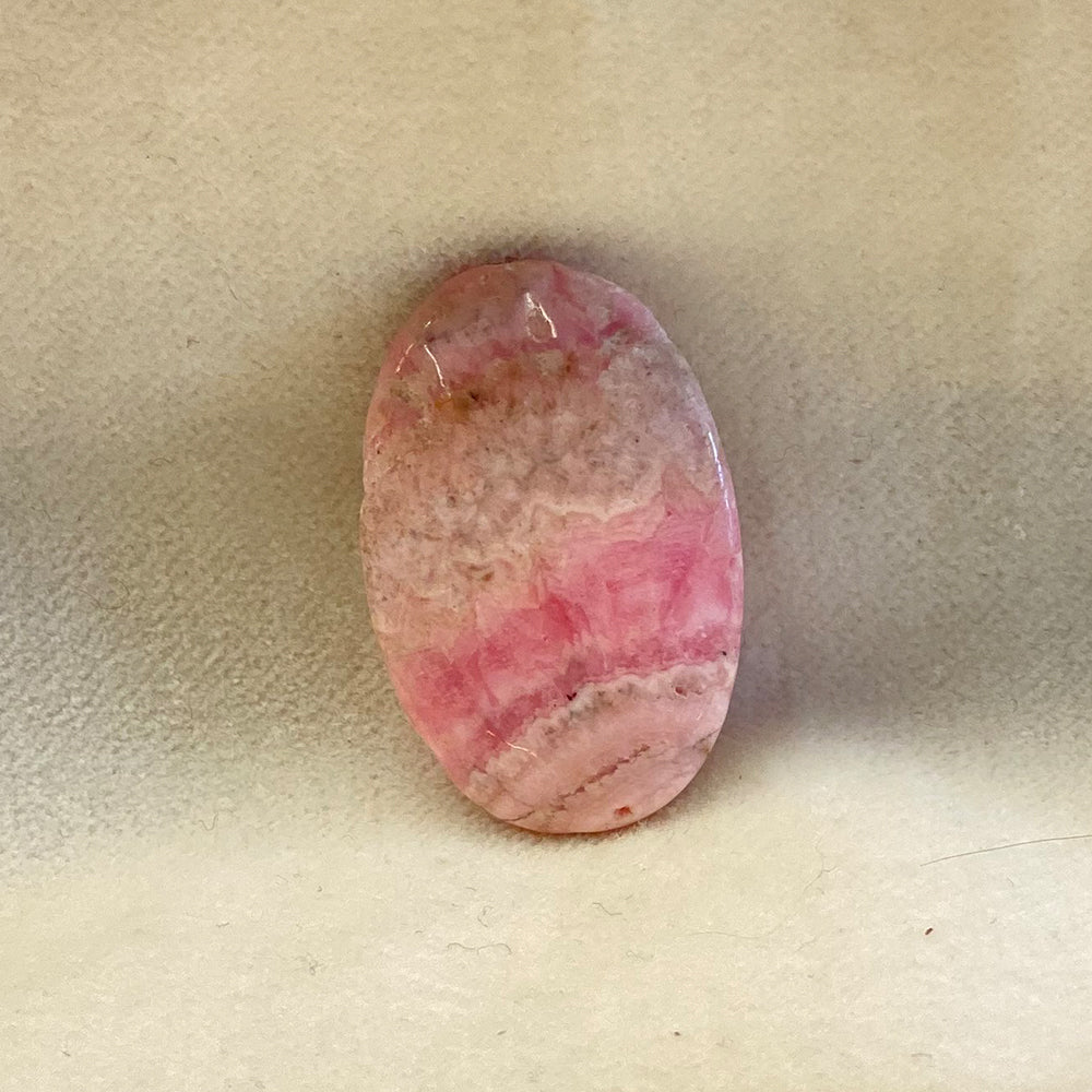 Rhodochrosite Oval Bead.  Handcrafted Rhodochrosite Flat Oval beads with stringing hole.  Polished smooth.  Size 1 1/4 inch. Really nice quality and hard to find.  Mystics call Rhodochrosite the stone of Love. 