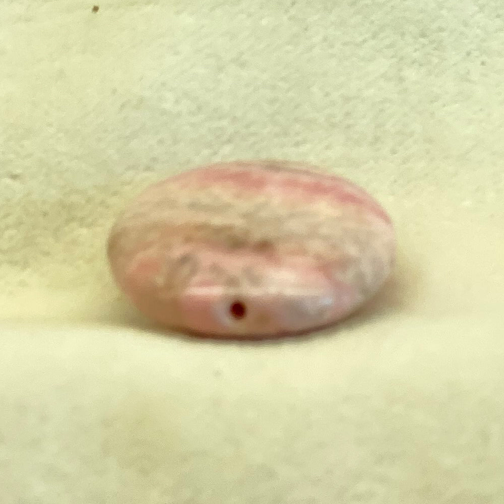 Rhodochrosite Oval Bead. Handcrafted Rhodochrosite Flat Oval beads with stringing hole. Polished smooth. Size 1 1/4 inch. Really nice quality and hard to find. Mystics call Rhodochrosite the stone of Love.