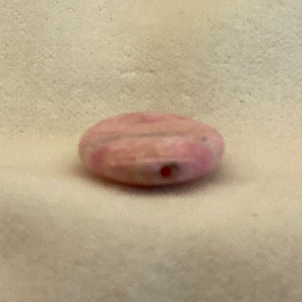 Rhodochrosite Oval Bead. Handcrafted Rhodochrosite Flat Oval beads with stringing hole. Polished smooth. Size 1 1/4 inch. Really nice quality and hard to find. Mystics call Rhodochrosite the stone of Love.