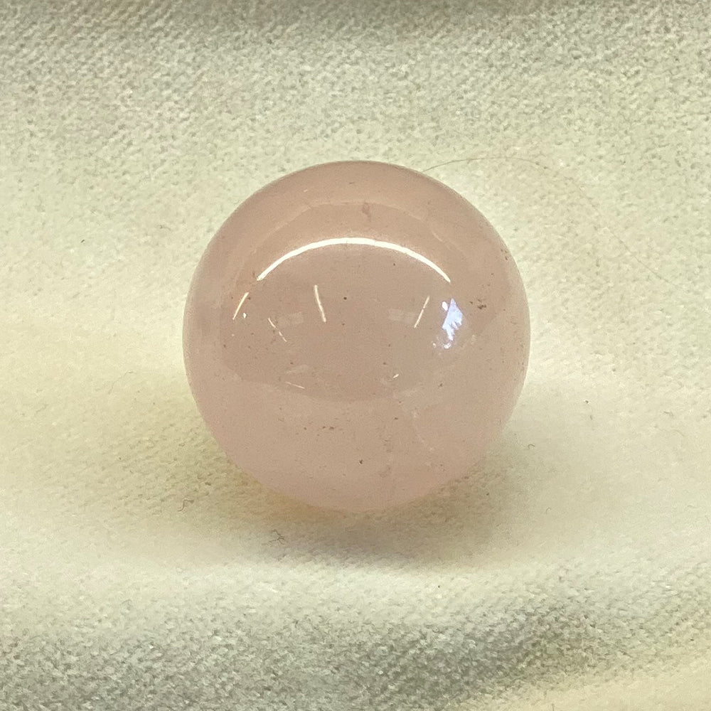 Rose Quartz Sphere. Perfect orb in a nice pink hue. Size: 3/4 inch. Rose Quartz folk lore says that rose quartz attracts love.
