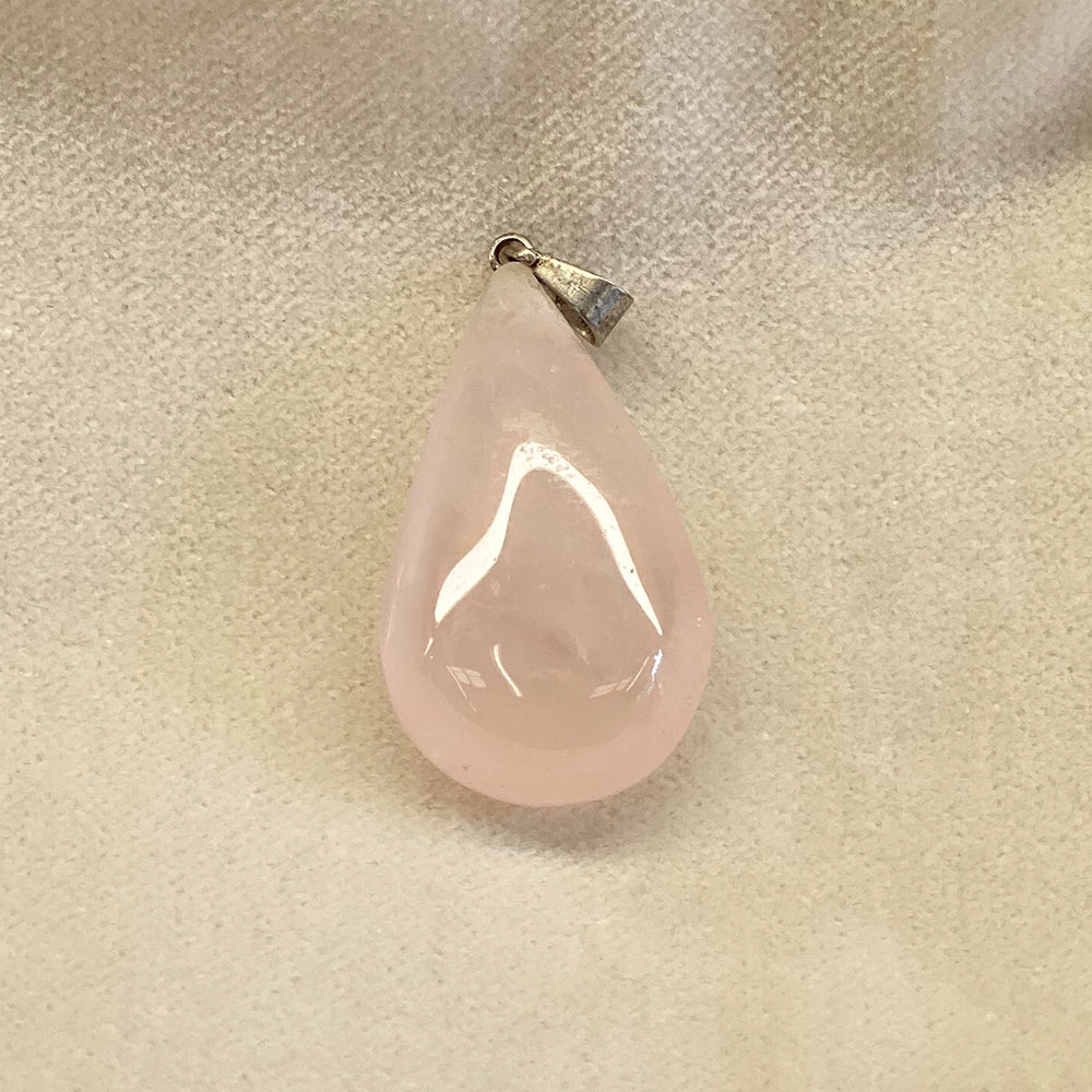 Rose Quartz Teardrop Pendant. Sweet petite pale pink stone. Great shape. Nice polish and very translucent. Average pendant size is 1 1/4 inch. Rose quartz is said to be the stone that attracts LOVE.