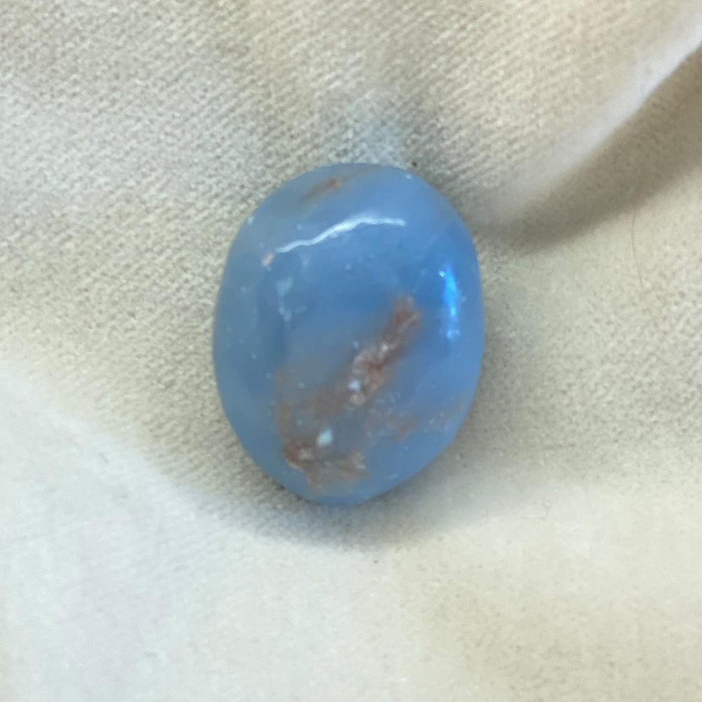 Tumbled, polished Angelite Stone. Milky blue in color. Mineral inclusions. Size: approx. 1 inch.