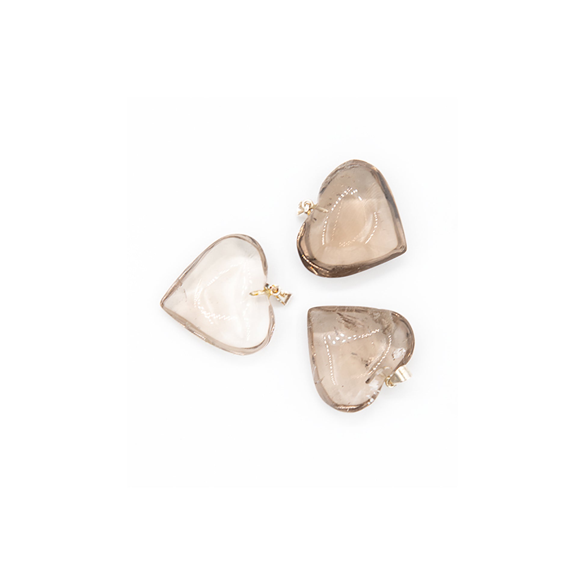 Glowing Smokey Quartz Heart Pendants.  These heart pendants are made in Brazil from fine Smokey Quartz that simply glows.   Totally translucent and smoothly polished these are fun to wear.   They measure a little over an inch.   Smokey quartz is said to be a great stone for grounding yourself.