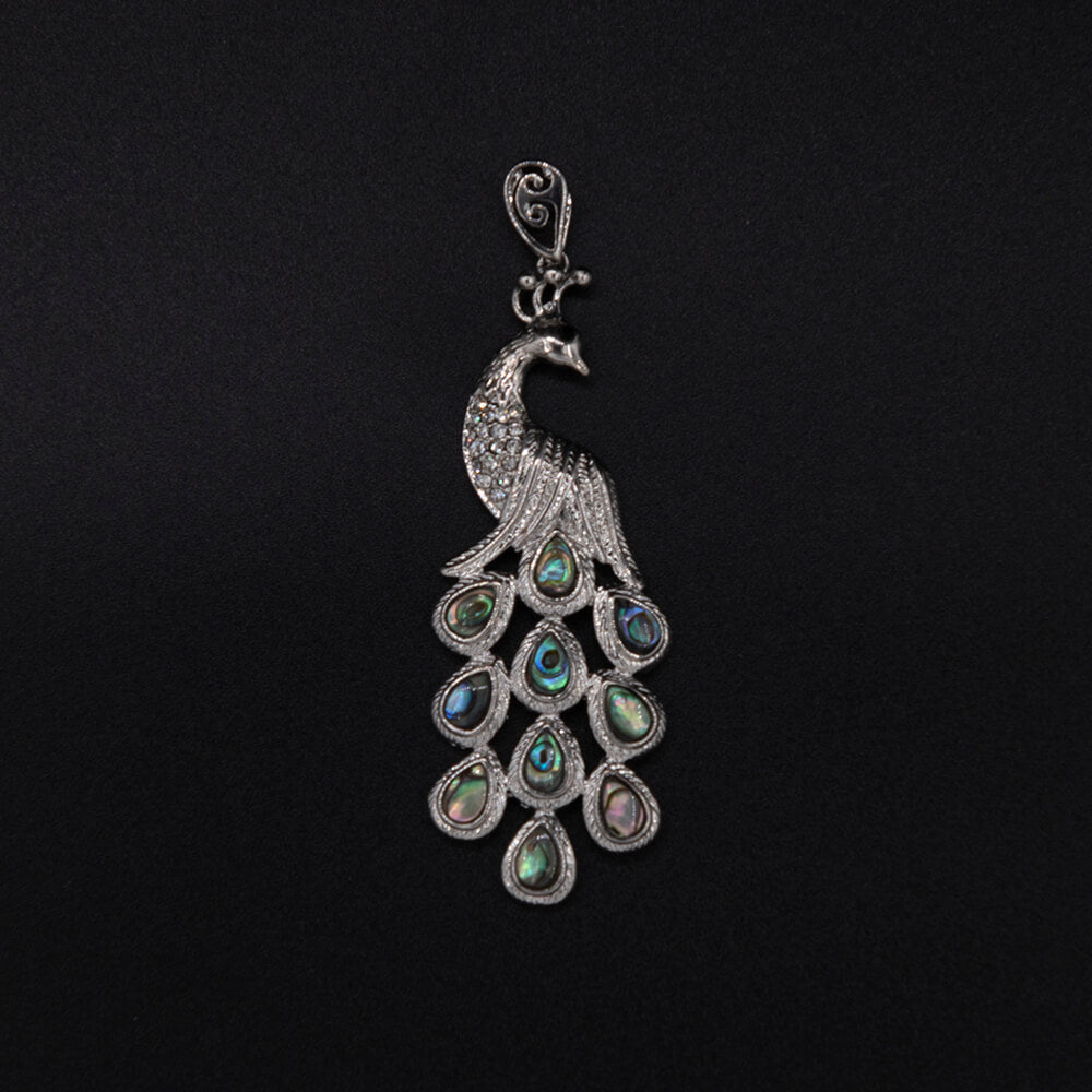 A 3 inch long, exquisite pendant that looks like a million but at a price that won't break the budget. The assorted Abalone shell cabochons in the tail just glow.