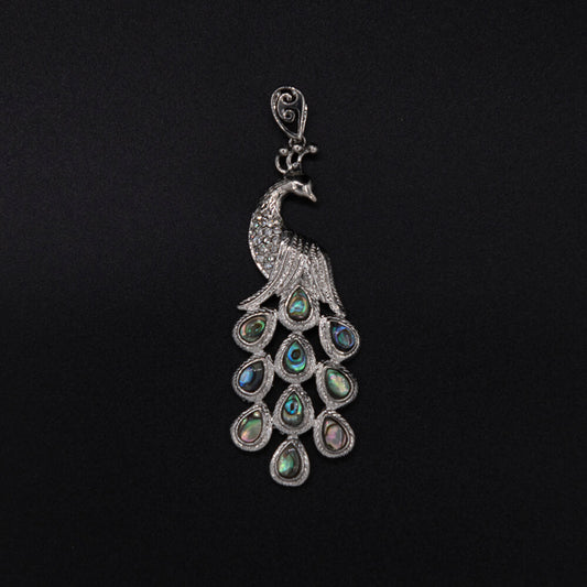 A 3 inch long, exquisite pendant that looks like a million but at a price that won't break the budget. The assorted Abalone shell cabochons in the tail just glow.
