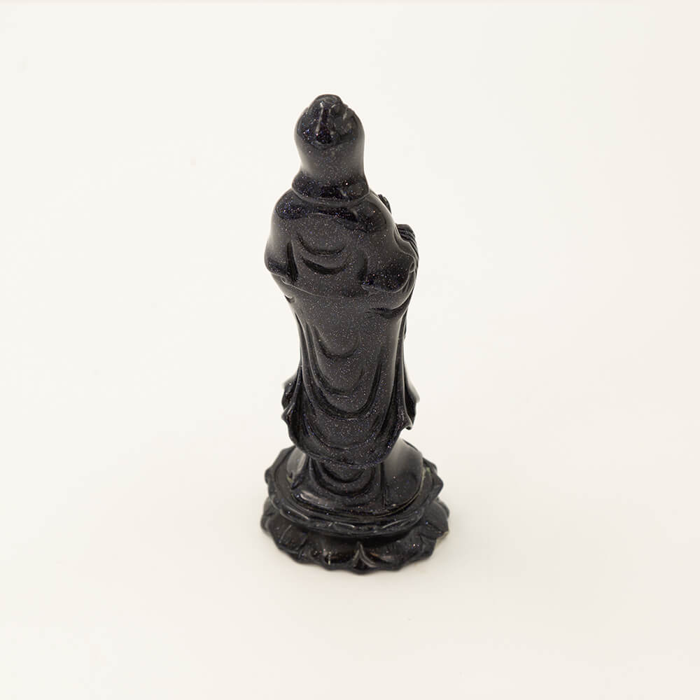Beautiful, detailed Kwan Yin statue made from Blue Goldstone.  Goldstone is a man-made quartz glass infused with copper particles, invented in 17th century Venice, Italy.  It is said to be an ideal stone for empaths.  Gorgeous, sparkly depth of color.  Size: 6x1.5x2 inches.