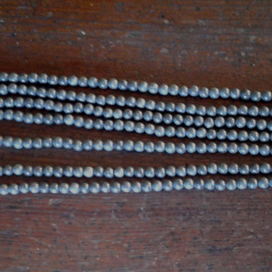 Exceptional Clear Creek CA jadeite beads in Gunmetal Gray.  Round beads with approx. 6mm diameter.  Strands are 16" in length.  Artisan quality.  Sourced from Clear Creek, in the San Panoche Mountains of San Benito County, CA