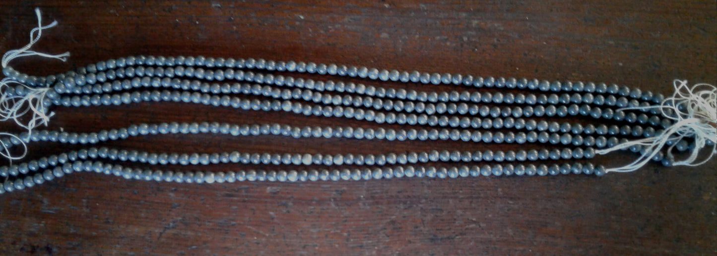 Exceptional Clear Creek CA jadeite beads in Gunmetal Gray. Round beads with approx. 6mm diameter. Strands are 16" in length. Artisan quality. Sourced from Clear Creek, in the San Panoche Mountains of San Benito County, CA