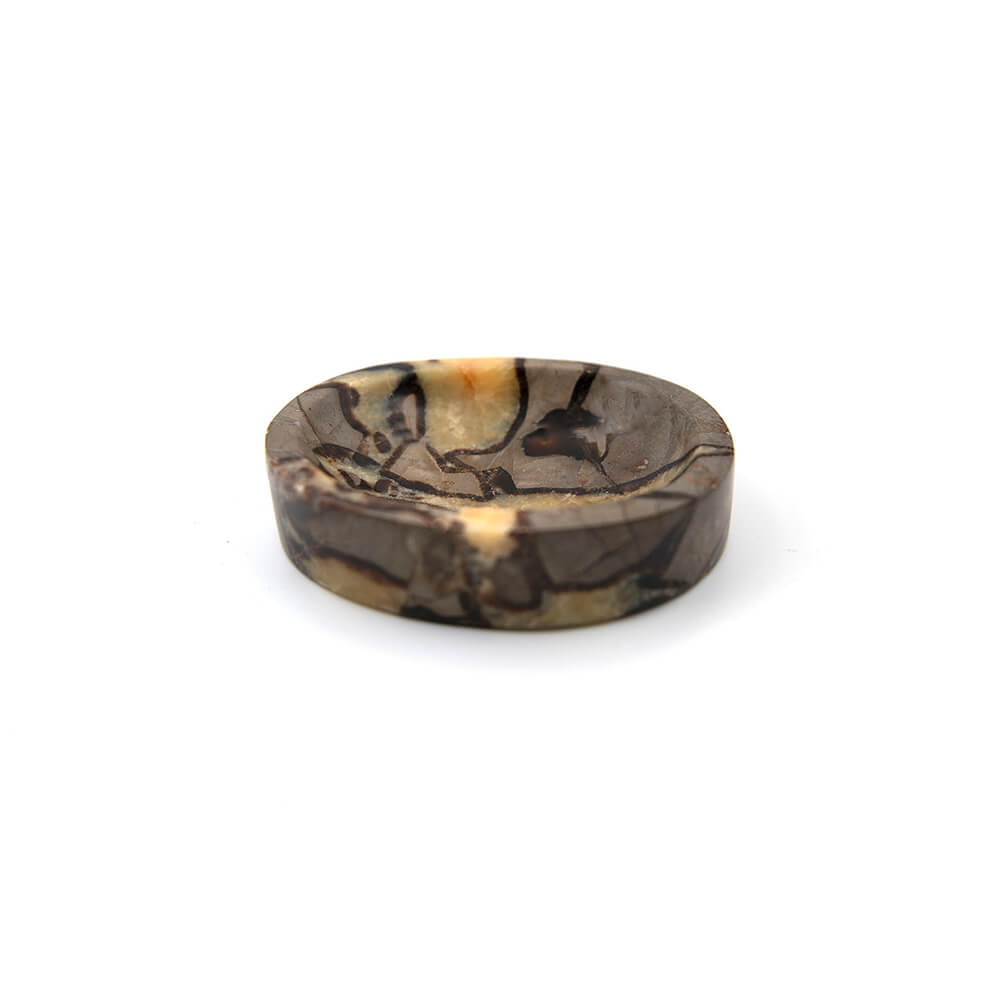 Nicely made Septarian bowl for your altar or coffee table.  A very unique pattern and nice polish.  Septarian is also referred to as Dragon Stone, known for its properties of grounding and protection.  Approx. 6x5 inches and over an inch high.