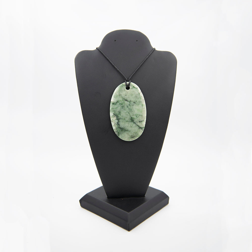 RiverBlossom Jade Oval Pendant.  Nice color and polish are featured on this highly patterned beauty.  The Jade used in this piece was sourced from our helicopter trips to our private property in the Trinity Alps area in California. We call this "RiverBlossom Jade" as the winter storms create high water that delivers the jade for us to simply pick up as the water recedes in the summer.