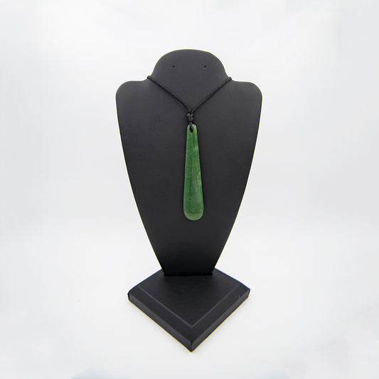 Canadian Jade Mere Pendant.  Beautiful Jade piece carved here in Mendocino, California but inspired by the New Zealand Maori weapon. The design is a symbol of protection from all evil. Very translucent and smooth all over. Jade sourced from Dease Lake Canada. 3.5 x.75 inches.