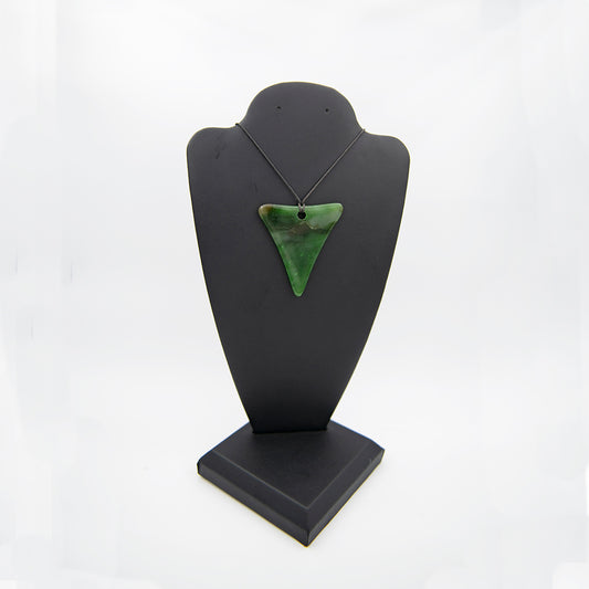 Polar Jade Triangle Pendant.  Eye catching shape in rare Polar Jade.  Top of the line craftsmanship, stone quality and handmade in Mendocino CA.  Sourced from Polar Mountain, British Columbia.  Varied nuances of color and very translucent.   Smoothly polished.   Size: 2 inches across the top and 2.5 inches along the sides.