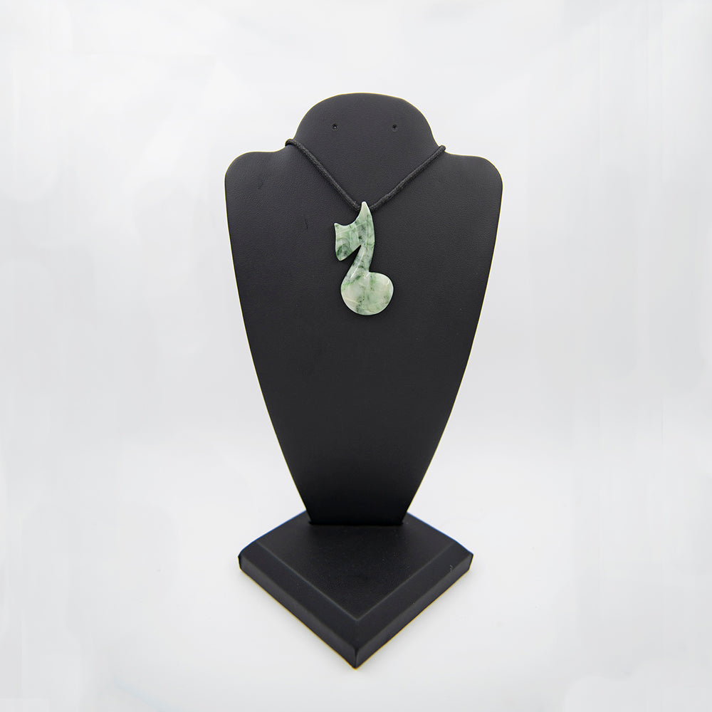 RiverBlossom Jade Musical Note Pendant.  Great work by a local Oregon carver who came to visit a couple of years ago and worked some of our Jades.  Over 2 inches in height and almost an inch in diameter.  The work is impeccable.  It is drilled for a nice cord.  The jade used in this piece was sourced from our helicopter trips to our private property in the Trinity Alps area in California