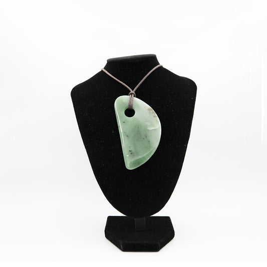 Siberian Jade Large Adze Style Pendant.  Beautiful translucent Jade from Siberia.  One of a kind.  Size: 4 inches long by 2 inches wide.  A large statement piece indeed.