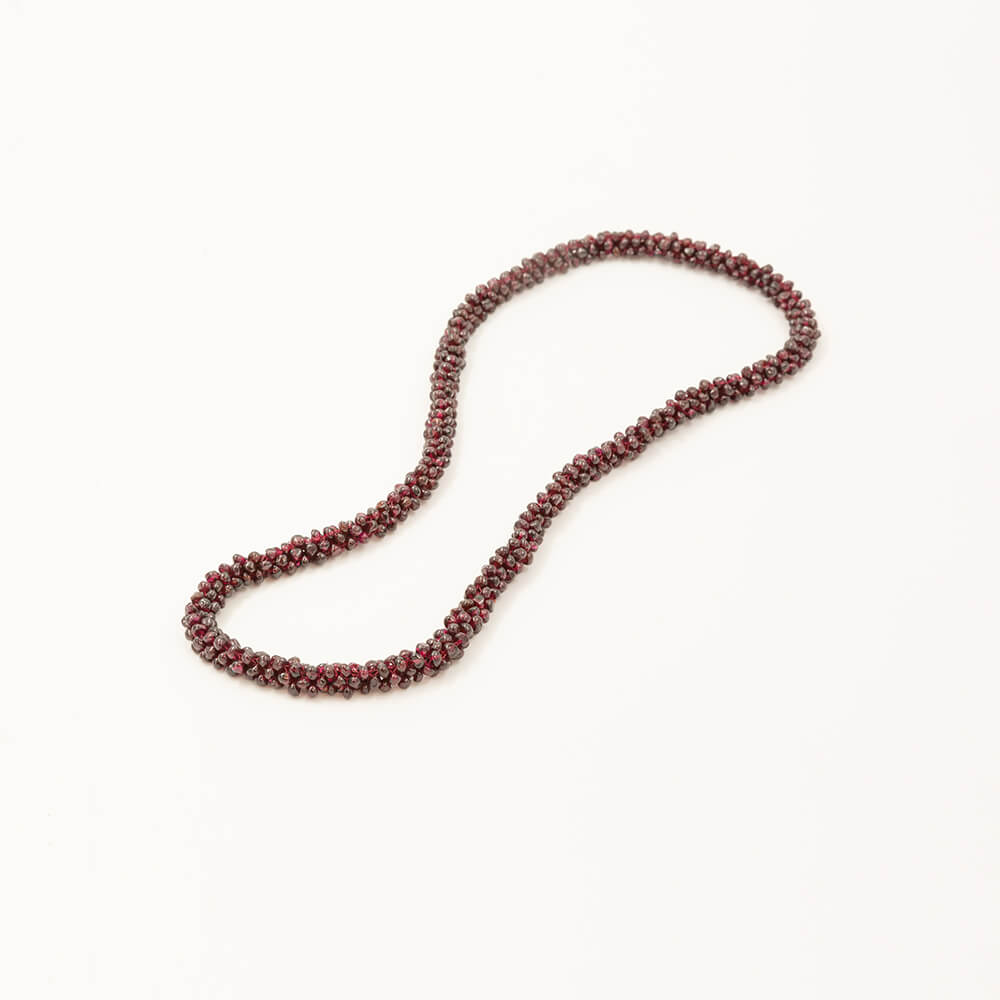 Fine, small Garnets woven into a rope-like necklace. Beautiful red colors. Smooth and comfortable to wear.