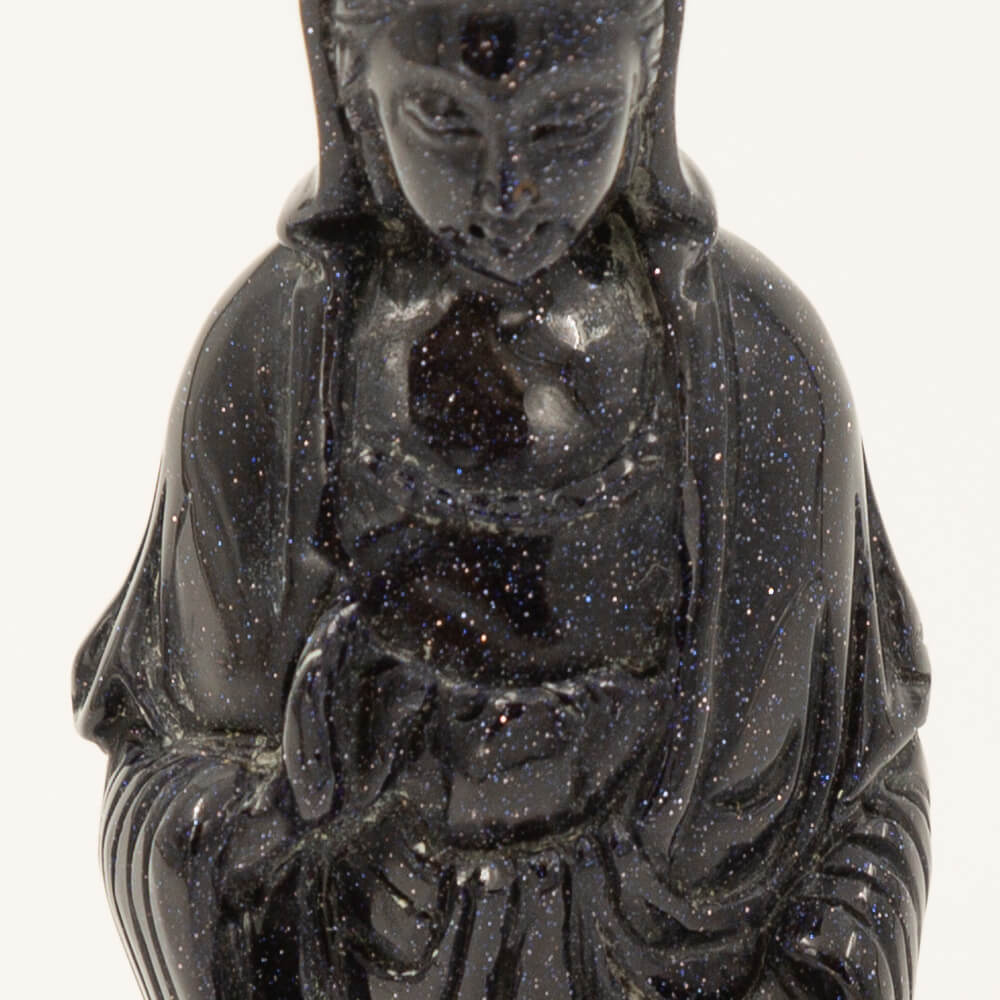 Beautiful, detailed Kwan Yin statue made from Blue Goldstone.  Goldstone is a man-made quartz glass infused with copper particles, invented in 17th century Venice, Italy.  It is said to be an ideal stone for empaths.  Gorgeous, sparkly depth of color.  Size: 6x1.5x2 inches.