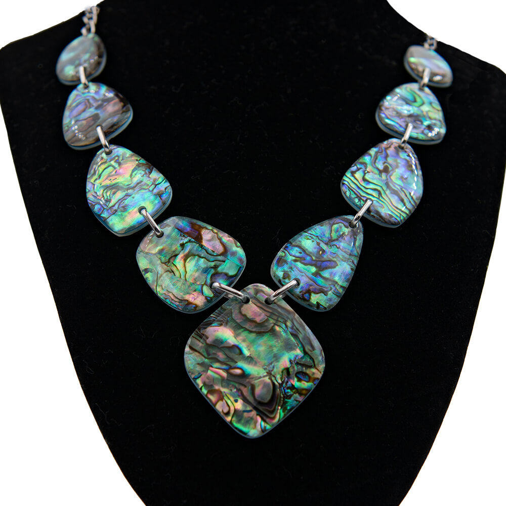 This Abalone piece really makes a statement. Blues, Purples, Rainbows and more in this eye catching as well as reversible necklace. The reverse side is white mother of pearl. The middle piece is a bit over 1 1/2 inches and the smallest is a bit less than an inch. The length can be adjusted up to 20 inches in length.