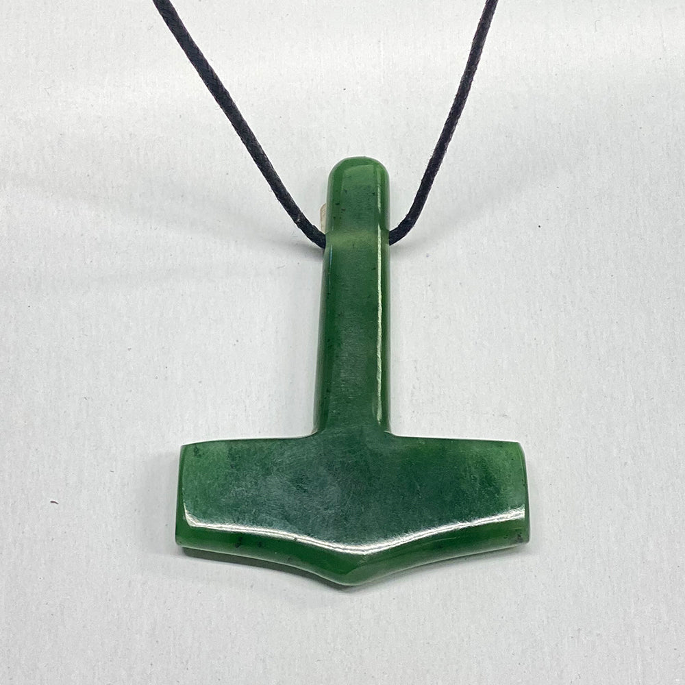 Lustrous green jade with black accents. Very masculine pendant, representing the thunderous power of the Norse god Thor.  Handmade in our lapidary facility near Mendocino, California.