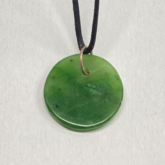 Mendocino Jade Circle Pendant.  Very translucent jade from Mendocino California. This unique piece is light green and a little over an inch in diameter. This is the exact piece you will receive.