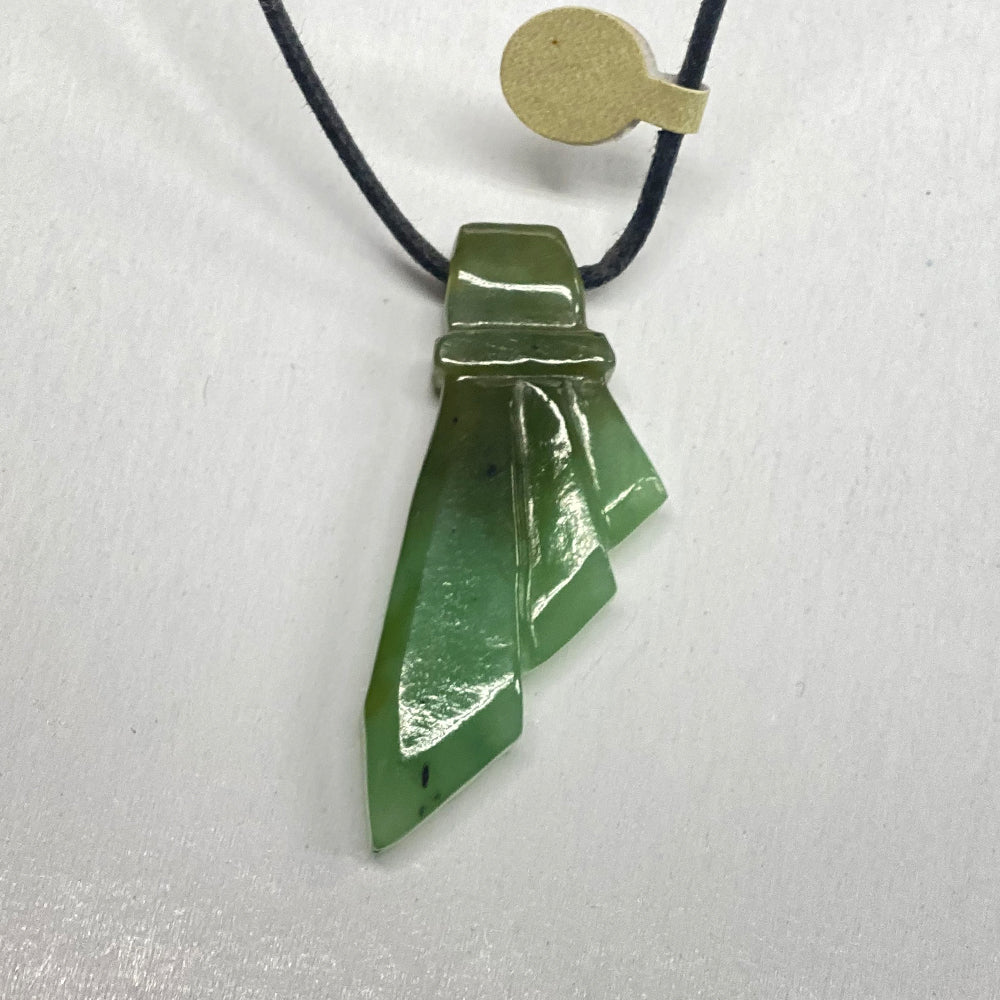 Jade Stylized Feather Pendant.  A unique shape done by a local Oregon fellow using an Imperial Green colored stone.   This piece is carved from Polar Jade.   Polar Jade is known as the hardest and greenest jade in North America.   It is sourced on Polar Mountain, British Columbia.  This jade is rare and quite expensive to purchase raw.