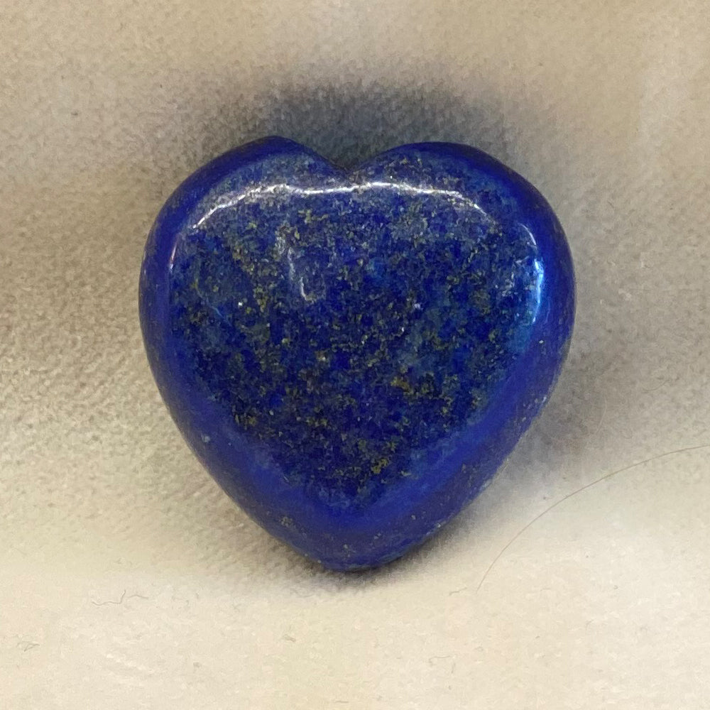 Lapis Lazuli Gemstone Heart.  Artisan crafted.  Deep blue with speckled mineral streaks or even pyrite are possible.  Smooth, polished surface.  Size: approx. 1 inch.The Mystics say Lapis Lazuli can help to heal emotional issues.