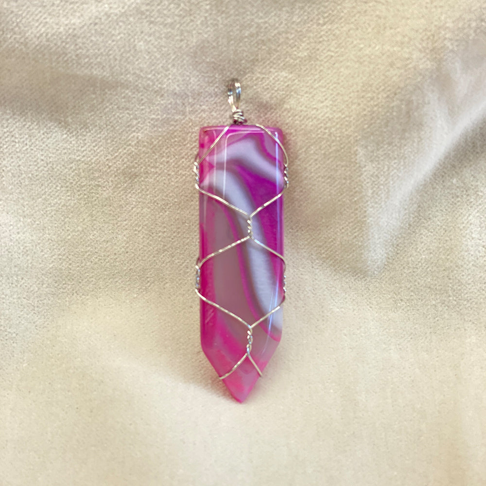 Wire Wrapped Fuchsia Agate Pendant.  Artisan made.  Stainless steel wrapping.  Size varies slightly.  Average size: 2.25 x .75  inches.  It has been said agate has a stabilizing effect.