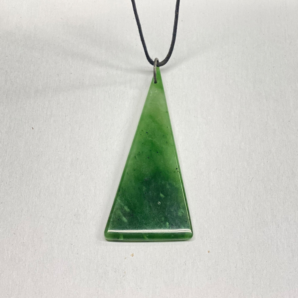 Cassiar Jade Triangle Pendant.  Super translucent with bright green inclusions that rare Cassiar jade is known for.   3 inches long and 1.25 inches wide.