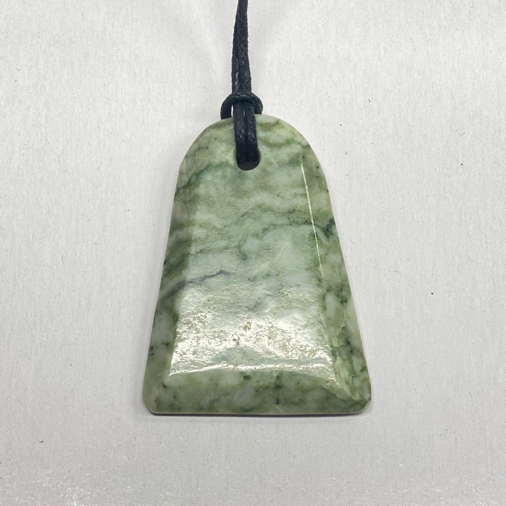 RiverBlossom Jade Adze Pendant.  Smooth, top quality craftsmanship defines this ancient shape.  The Jade used in this piece was sourced from our helicopter trips to our private property in the Trinity Alps area in California.   We call this "RiverBlossom Jade," as the winter storms create high water that delivers the jade for us to simply pick up as the water recedes in the summer.