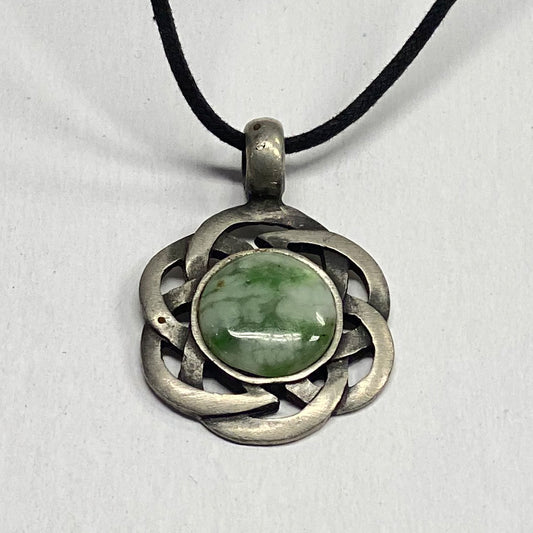 RiverBlossom Jade Celtic Knot Pendant.  Pewter metalwork in the shape of a Celtic Knot.  The Jade used in this piece was sourced from our helicopter trips to our private property in the Trinity Alps area in California.  We call this "RiverBlossom Jade."