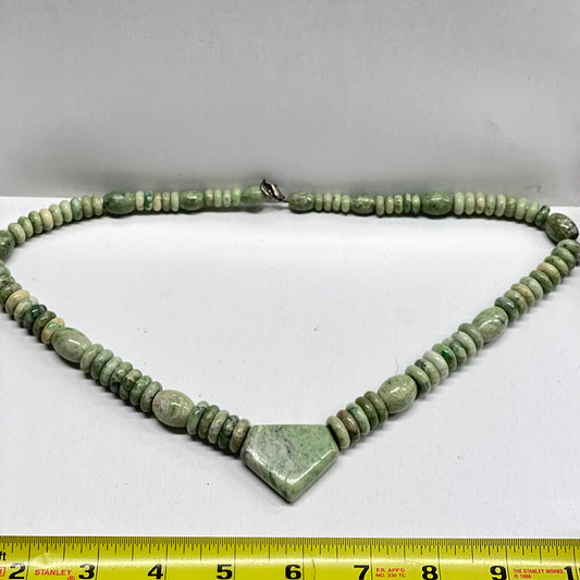 RiverBlossom Jade Superman Necklace.  My grandson calls this the Superman necklace because he says the 5 sided shape of the center stone reminds him of the Superman logo shape.  A very masculine piece.  This entire piece is graduated and tapered with barrels and rondelles of our RiverBlossom Jade. The Jade used in this piece was sourced from our helicopter trips to our private property in the Trinity Alps area in California.